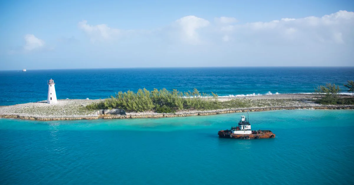 A lighthouse and turquoise water along the Bahamas coastline